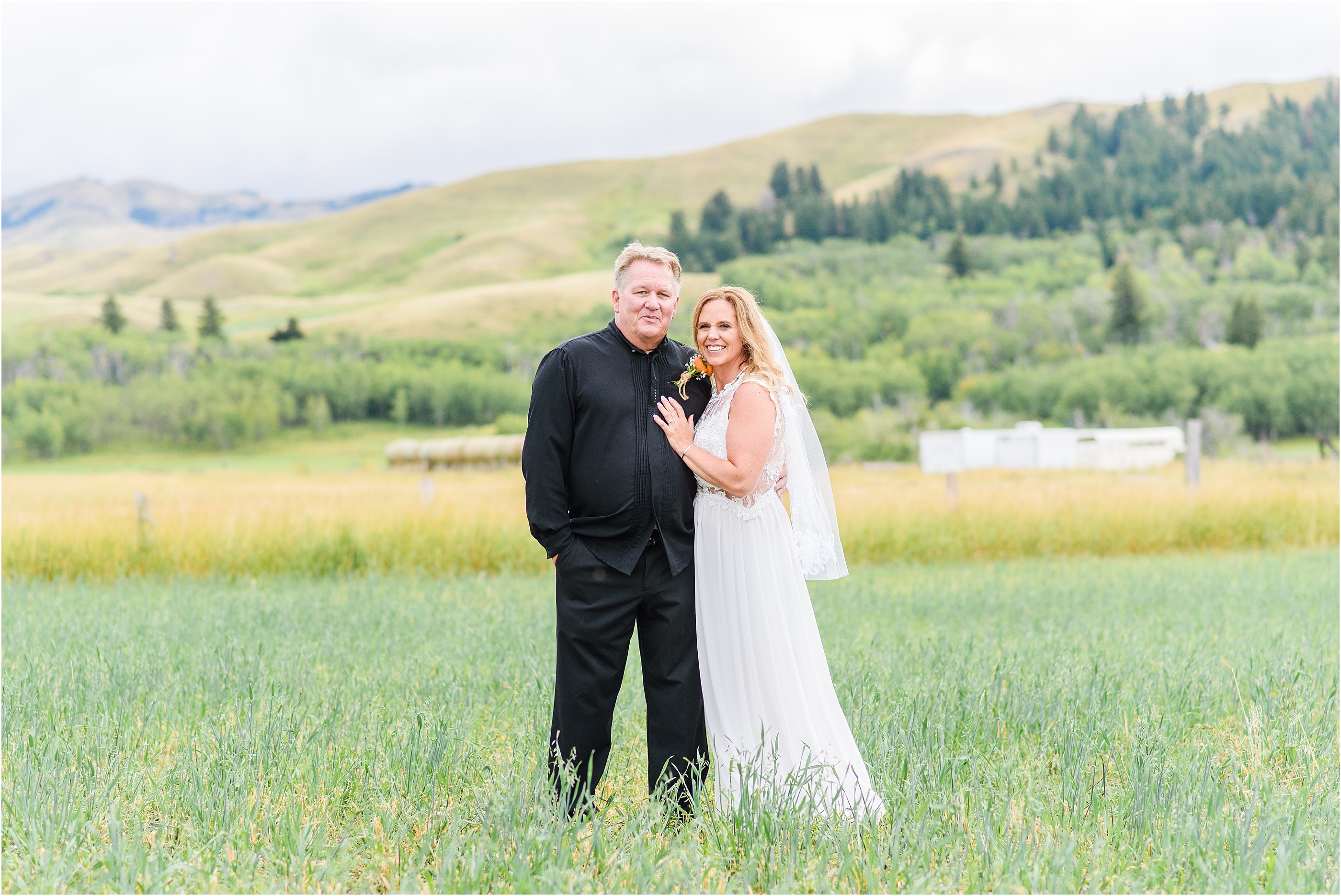bride and groom taking portraits in mountain montana